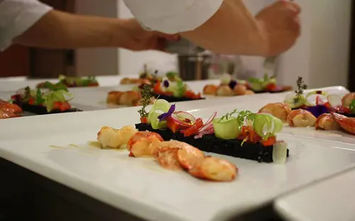 Chef serving food at the Villa Luppis