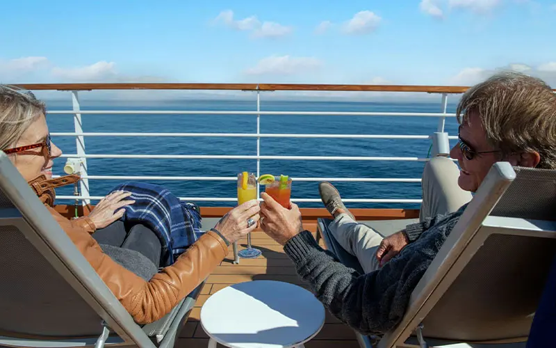 Couple enjoying cocktails on the Sundeck
