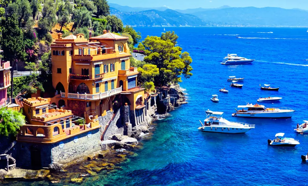 Luxurious seaside villas of Portofino, Italy. Scenic cove with boats in the Mediterranean Sea.